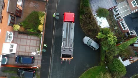 january 2019 - aerial view, footage of dustmen putting recycling waste into a garbage truck, bin men, refuse collectors