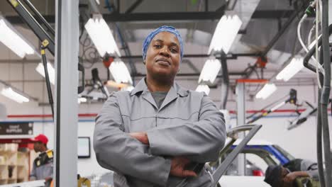 african american female car mechanic crossing her arms and looking at camera