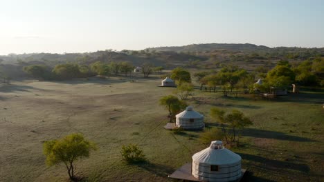 traditional mongolian ger yurts in the grasslands of central asia at sunrise