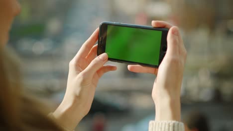 woman looking phone green screen. closeup girl using phone with chroma key.