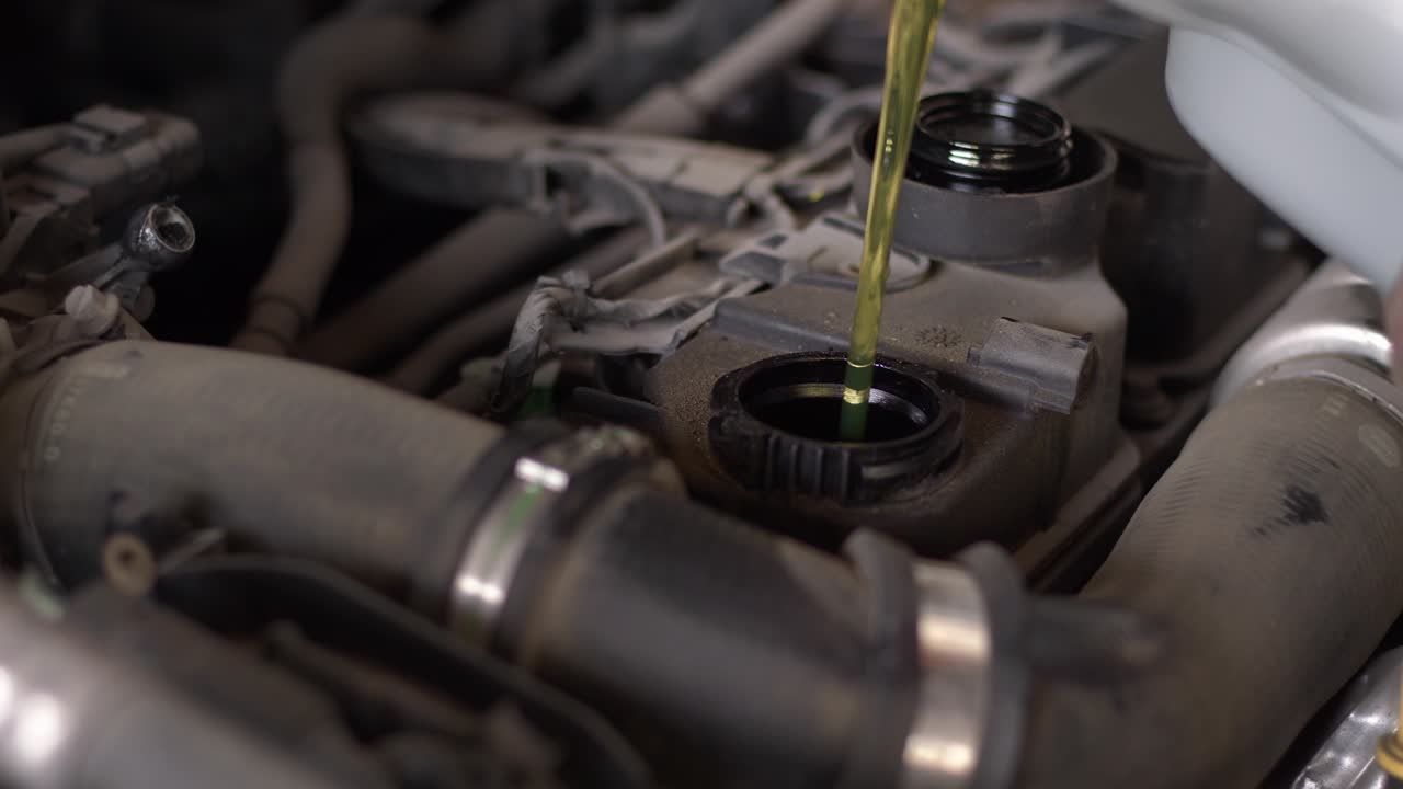 Car Master Pours New Synthetic Engine Oil Into Car Engine In The Repair Shop