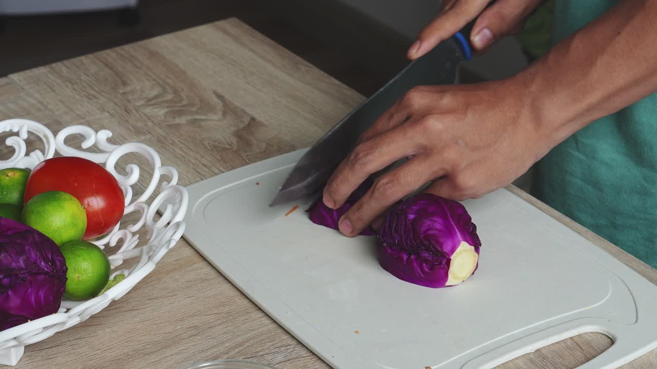 Top View Shot Of Man Hands Slicing Purple Cabbage For Salad Ingredients