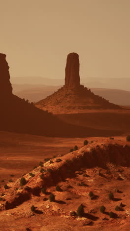 red desert landscape with rock formations at sunset