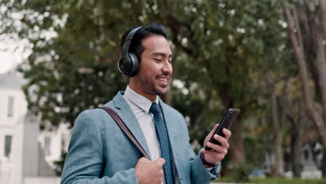 Headphones,-phone-and-businessman-walking-outdoors