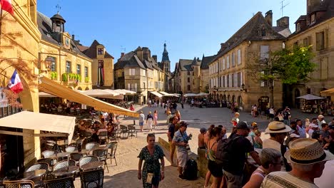 crowded street with cafes and historic buildings