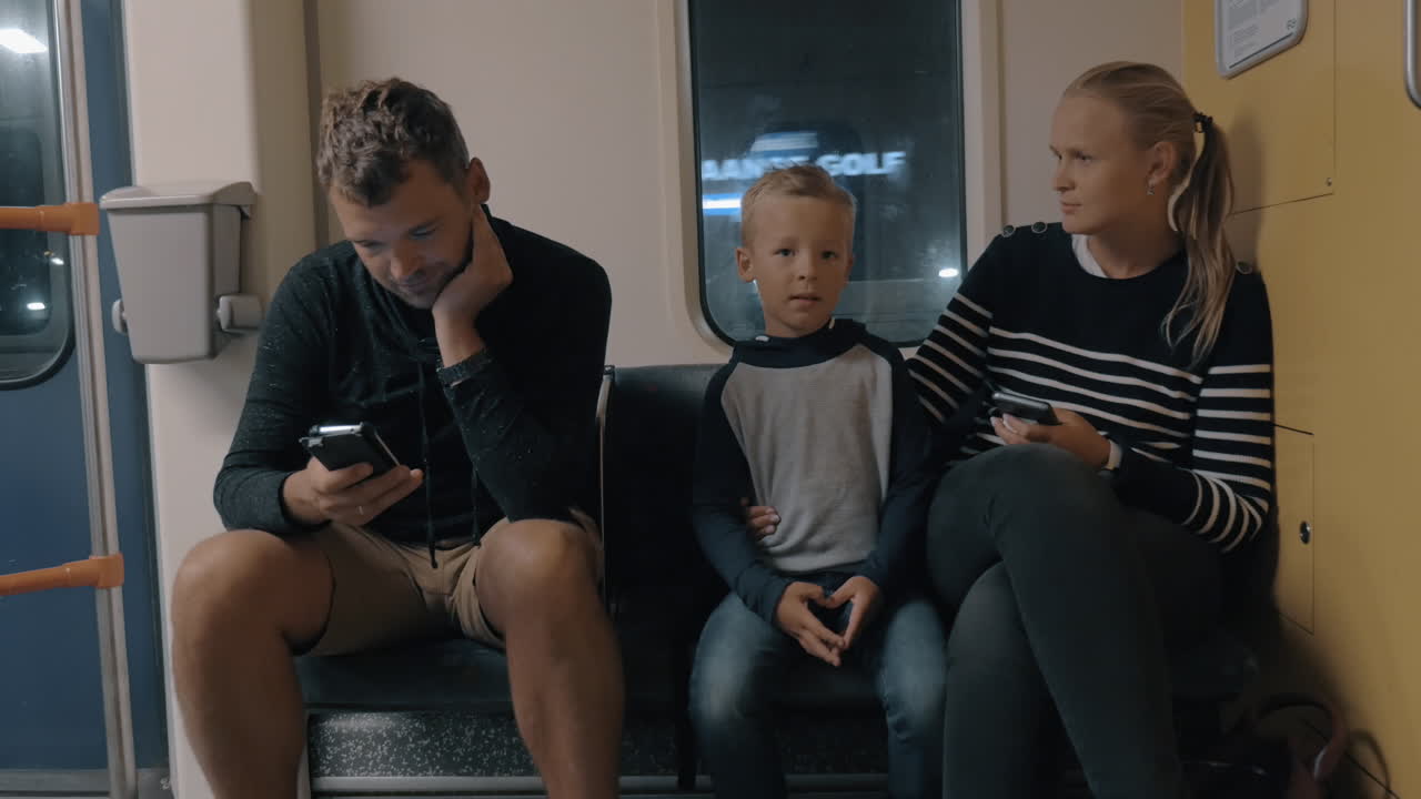 Parents and child traveling in subway train