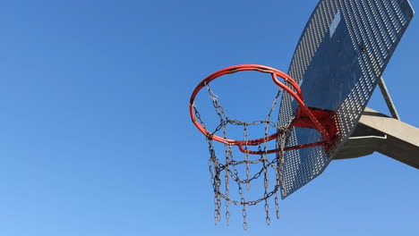 Still-shot-from-below-basketball-hoop-on-blue-sky