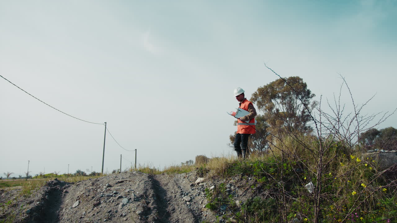 Building Engineer Arriving At The Construction Site With Project And Notes