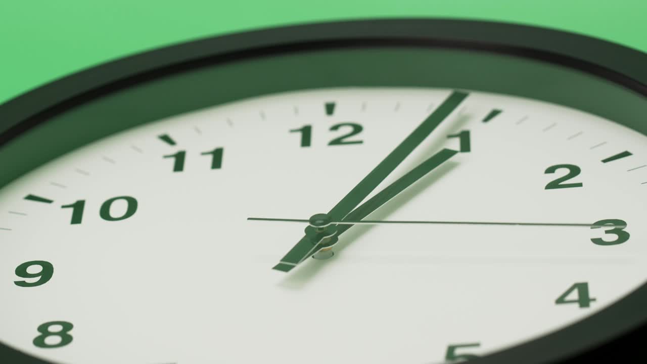 Close up White Wall clock number one second hand rotates with time.
