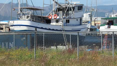 port of astoria boatyard closeup of blue and white fishing boat on a sunny day in 2020