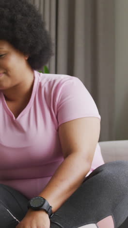 video of midsection of plus size african american woman in sport clothes preparing for exercising