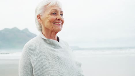 Senior-woman-standing-on-beach