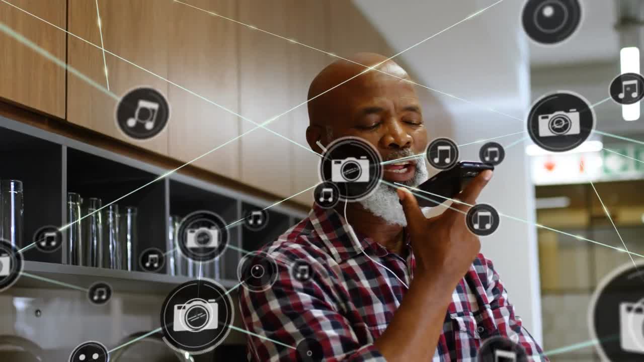 Animation of network of connections with icons over biracial businessman using smartphone