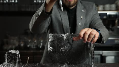 bartender carving ice for cocktails
