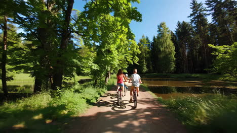 family biking through a sunny park