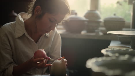 young ceramist doing handcraft in pottery