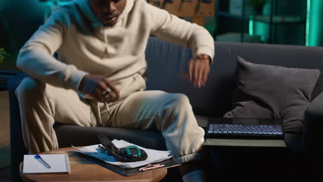 african american diabetic person working from home in his cozy apartment, using an insulin pen and measuring his glucose levels. young adult with illness uses glucometer. camera a.