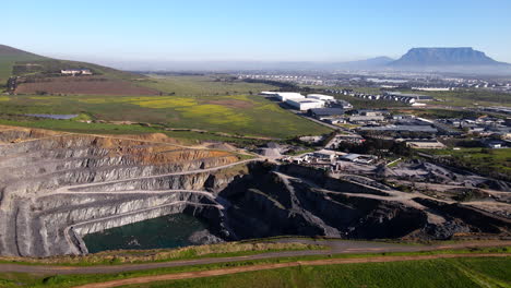 large scale open cast mine on south africa west coast, view of table mountain