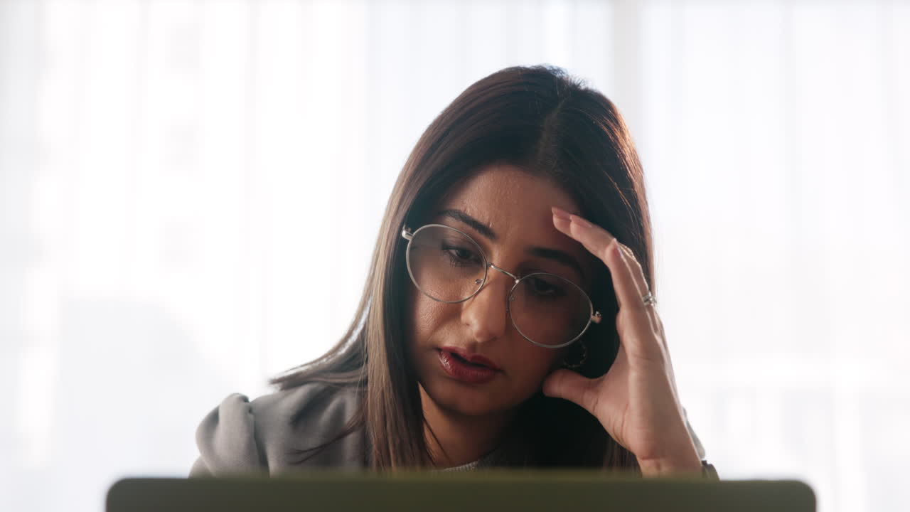 A stressed woman working at her computer