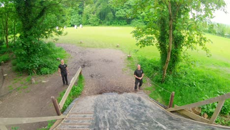 fit men training over obstacle course 4k
