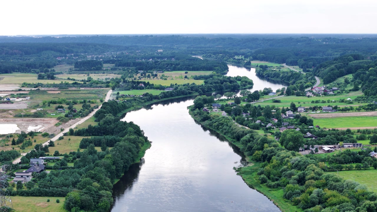 Winding Neris river and small settlements, aerial drone view