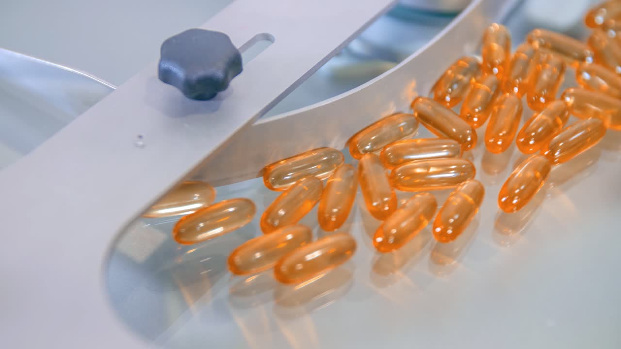 Transparent orange-yellow pills for coronavirus outbreak during counting process