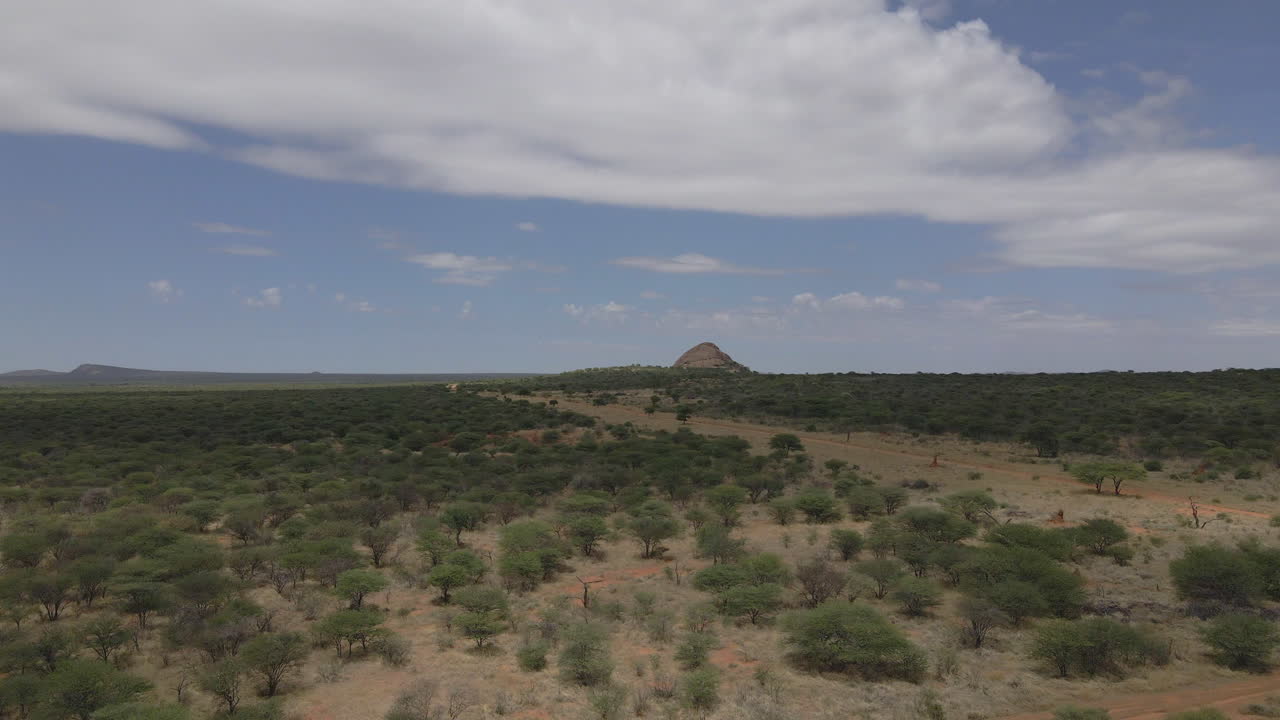 drone view of a Jeep navigating Namibia's vast landscapes, showcasing stunning deserts, rugged terrain, and endless horizons in an epic adventure through nature's beauty.