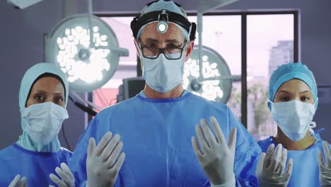 front view of surgeons gesturing while standing in operating room at hospital