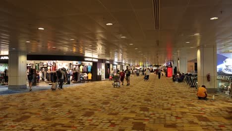 crowds navigating through a bustling airport terminal