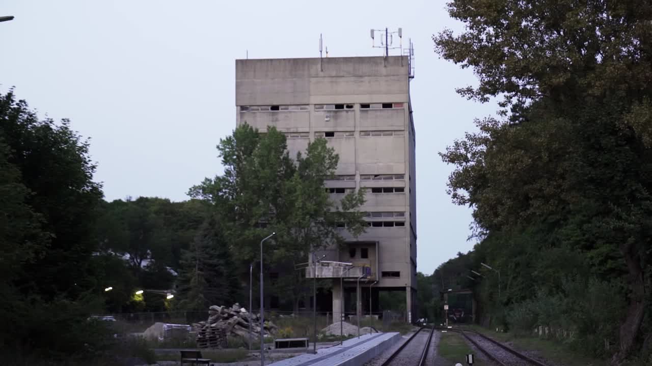 Abandoned Concrete Building Near Railroad Tracks