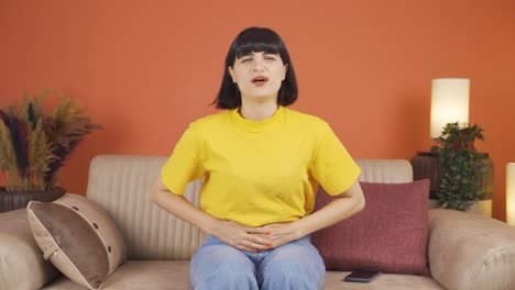 woman experiencing stomachache.