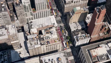 slow motion landscape of new york city intersection cars and taxi at traffic lights on busy streets with buildings towers urban structures manhattan brooklyn usa america travel tourism
