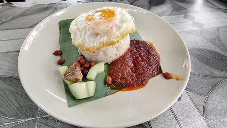 a plate of nasi lemak, malaysia's national dish, featuring a balanced mix of nutrients. traditionally enjoyed in the morning, it’s a flavorful and wholesome start to the day.
