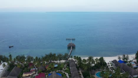 aerial drone shot tilting down to a pier of an hotel. zanzibar, tanzania.