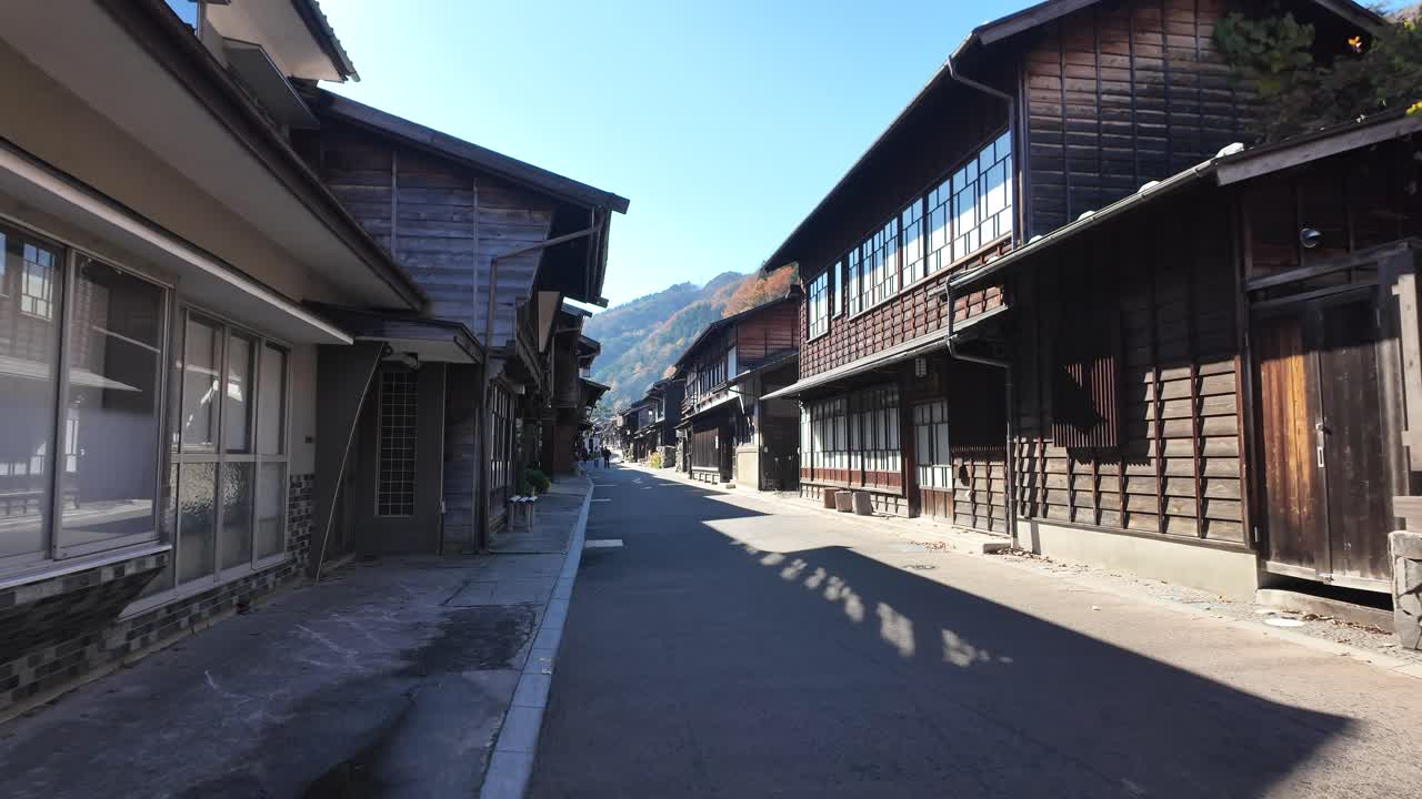 POV Along Scenic view of traditional wooden buildings in Narai-Juku, a historic Japanese post town.