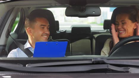 man and woman driving in a car, smiling and laughing