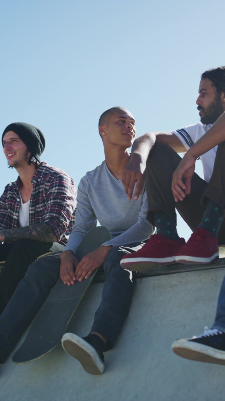 Group of Young Skateboarders Sitting and Talking at Skatepark