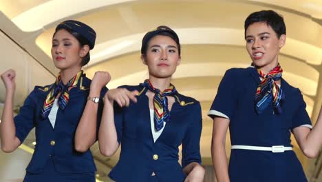 cabin crew dancing with joy in airplane