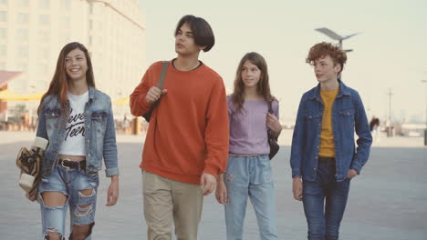 a group of teenagers walk down the street 2