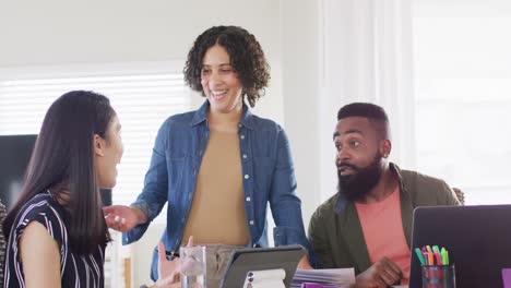 Diverse-happy-male-and-female-friends-talking,-using-laptop,-working-at-home,-in-slow-motion