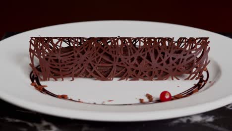 a person decorated a chocolate with red cherries, close up shot, insert shot, wide shot