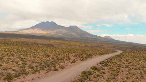 establishing cinematic shot following a dirt road in the atacama desert, chile, south america