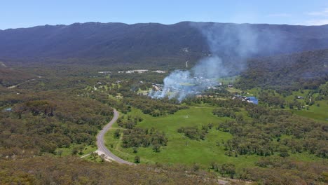 forward drone view of smoke spreading over crackenback area in new south wales, australia