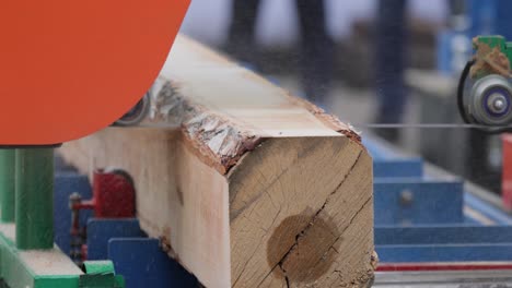 Work-of-the-sawmill-in-close-up.-Process-of-machining-logs-in-equipment-sawmill-machine-saw-saws-the-tree-trunk-on-the-plank-boards.