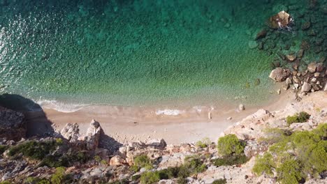 hidden sandy pasjaca beach in dalmatia, croatia - aerial top down forward