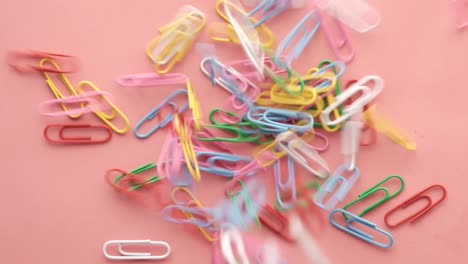 colorful paperclips on a pink background