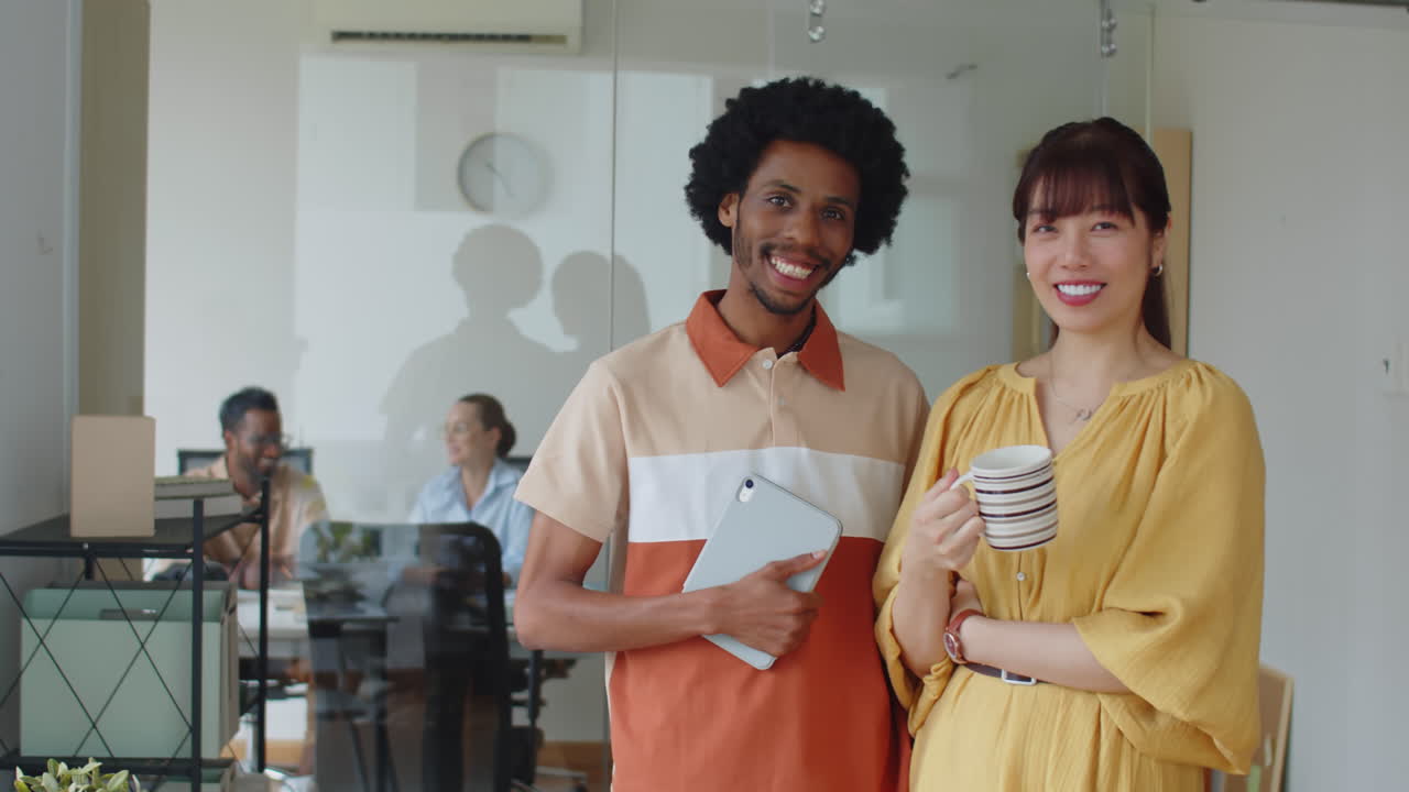 Portrait of Biracial Employees Chatting at Office