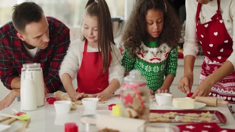 family preparing christmas cookies in the kitchen