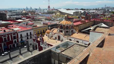 aerial tilt down shot of historic cathedral in puebla city during sunny day, mexico