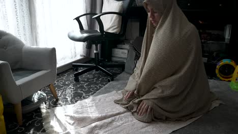 muslim women, draped in traditional attire, engage in prayer, showcasing devout religious commitment within the serene sanctuary of home, nurturing spiritual devotion and connection